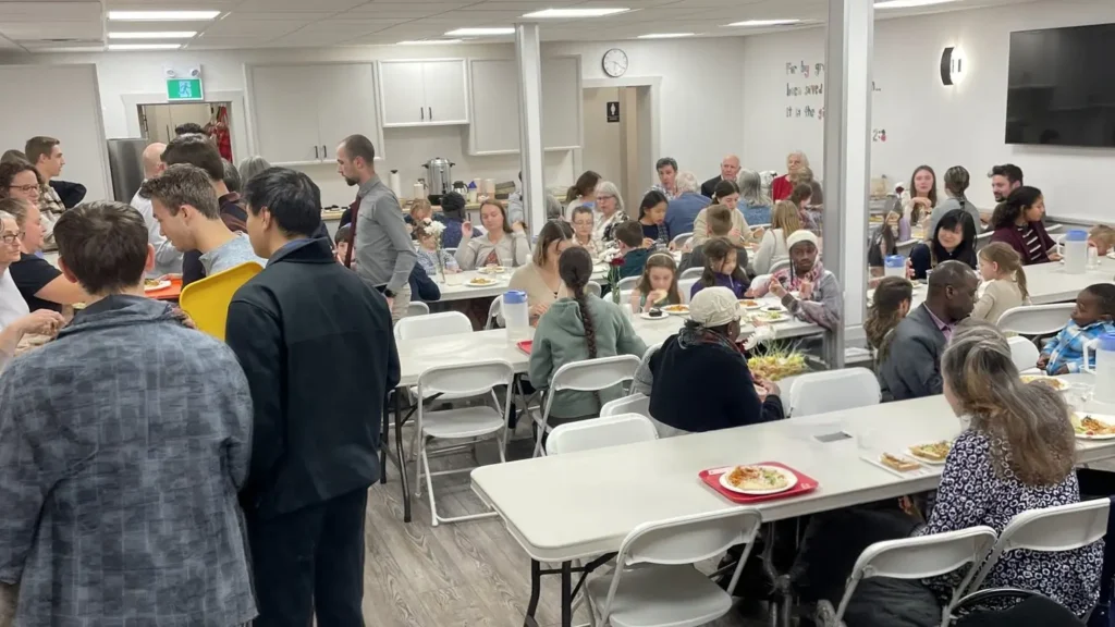 People sharing a meal at a past community gospel supper.