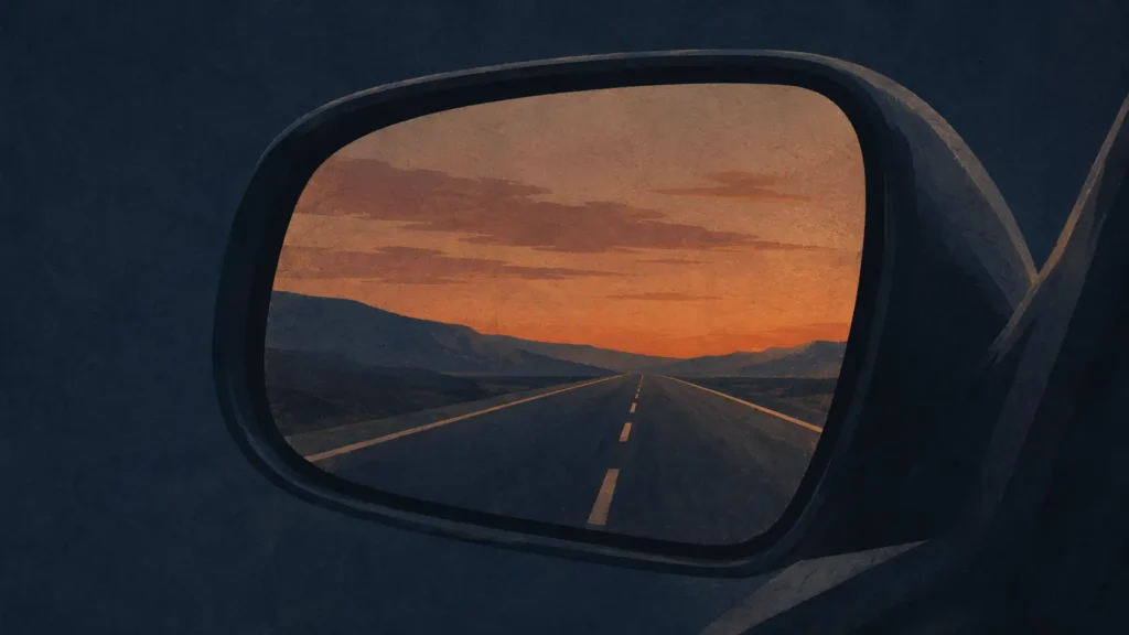 Empty highway reflected in a car's rearview mirror at dusk, evoking sin unnoticed until judgment