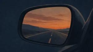Empty highway reflected in a car's rearview mirror at dusk, evoking sin unnoticed until judgment