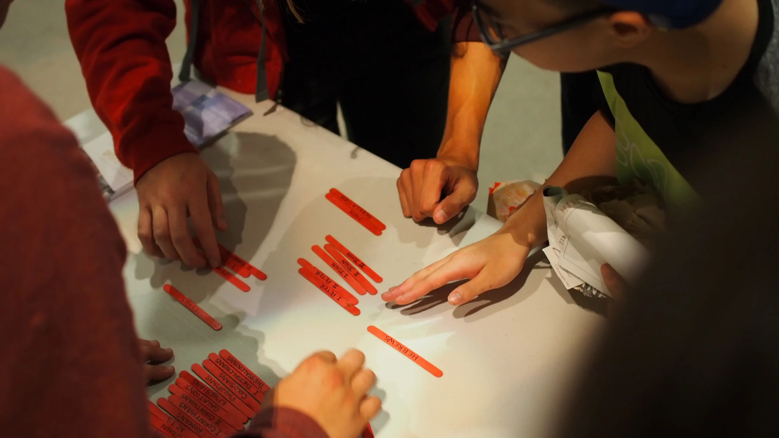 Students organizing the books of the Bible in order.